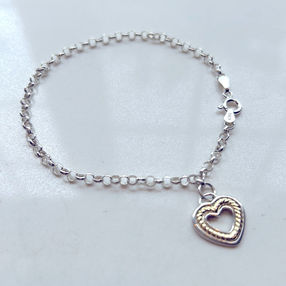 Beautiful sterling silver and 18k gold heart charm bracelet. Adjustable